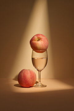 Elegant Composition of Peaches and Wine Glass in Spotlight