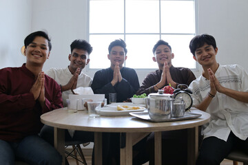 Group of Muslim Men Showing Greeting Hand Gesture in The Dining Table During Ramadan Celebration