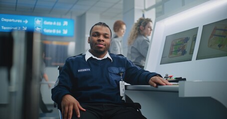 Airport Security Checkpoint: Portrait of African American TSA Worker Looking at Camera. Computer...