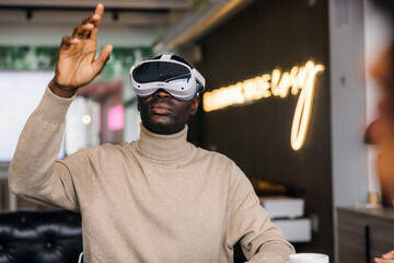 Black Man immersed in virtual reality experience with headset