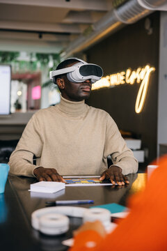 Black man in Immersive VR experience in modern office setting