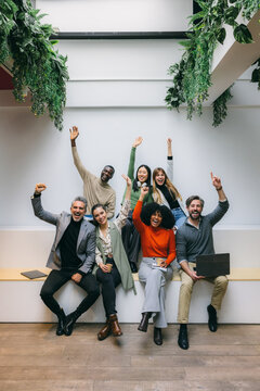 Diverse team celebrating success in modern workspace