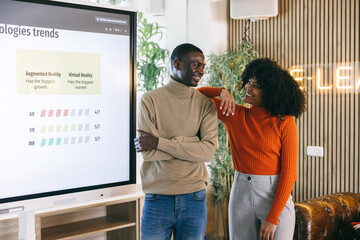 Colleagues Discussing Technology Trends in Modern Office