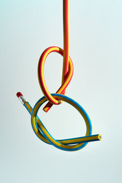 Abstract still life with flexible pencils on a light background. 