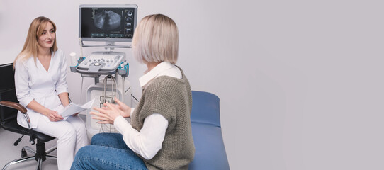 Female professional doctor studying ultrasound examination results reading medical records, case history, examination report thinking about diagnosis at workplace in office communicating with patient