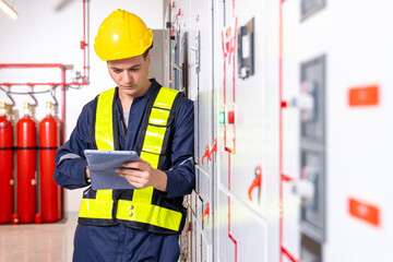 Construction electrician engineer caucasian male working with laptop in concept of good management electrical system for construction, logistic transportation business in workplace area.