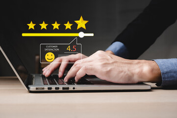 Customer satisfaction feedback review concept. Buyer types on a keyboard to write product or service experience and gives 5-star rating. Customers review the online shopping platform