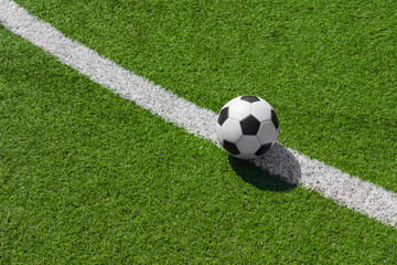 a soccer ball on the green grass on the line in soccer stadium.