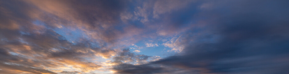 Beautiful blue sky with a few clouds and a pinkish hue