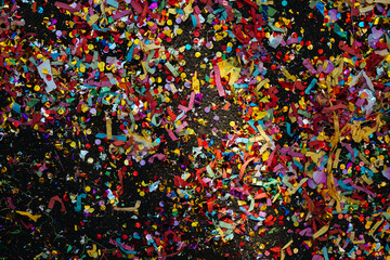 Multicolored confetti scattered on the ground