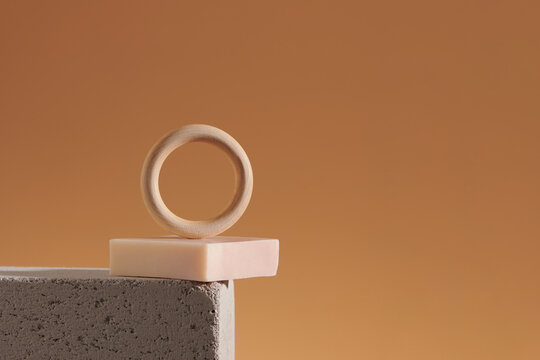 solid shampoo bars with wooden ring on light brown background