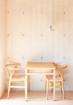 Minimalist Dining Area with Wooden Table and Concrete Wall