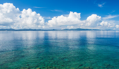 Seascape with Turquoise Waters, Blue Sky and Distant Mountains
