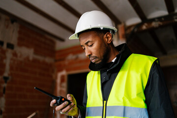 Construction manager using walkie talkie during building inspection
