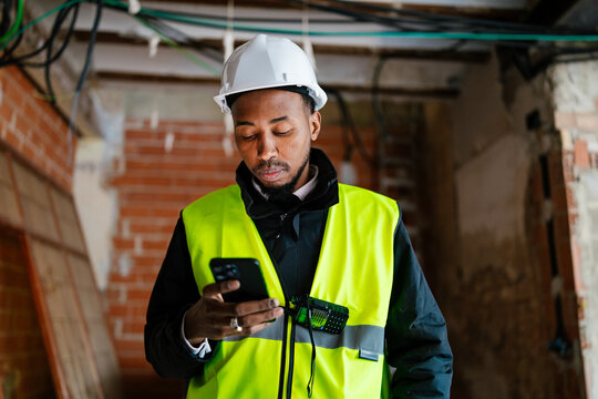 Construction manager using a smartphone on the construction site