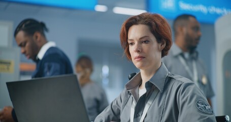 Airport Security Checkpoint: Close Up of Female TSA Officer Working on Laptop. Transportation...