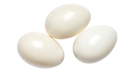 High-protein concept. Three smooth, white eggs on a black background.