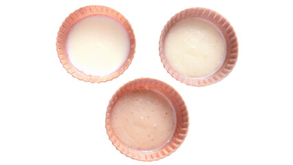 High-protein concept. Three bowls of different colored liquids on a black background.