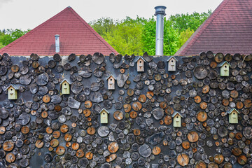 Lovely Wall of Wooden Logs and Birdhouses in Nature