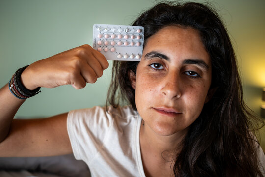 Portrait of a Woman Expressing Distress with Birth Control Pills