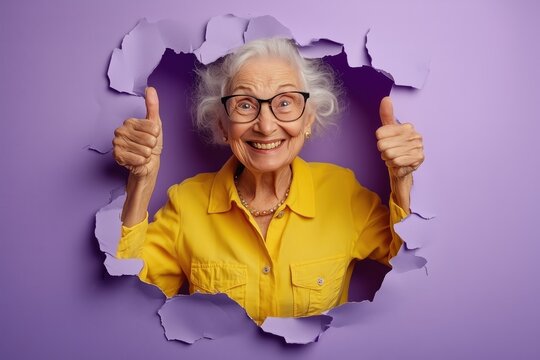 nergetic senior woman breaking through paper with a smile - Powered by Adobe