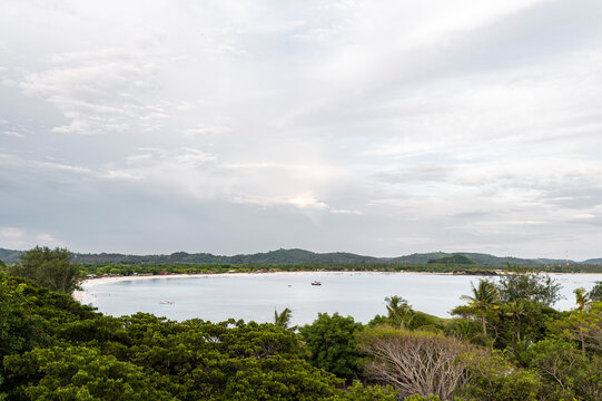 Serene view of Tanjung Aan beach with Mount Rinjani in the background, Lombok, Indonesia