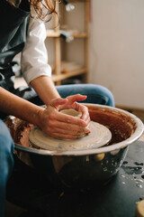Potter creates a ceramic bowl in the pottery studio. Process of making a unique ceramic shape.