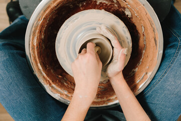 Process of making a unique ceramic shape. Potter creates a ceramic bowl in the pottery studio.