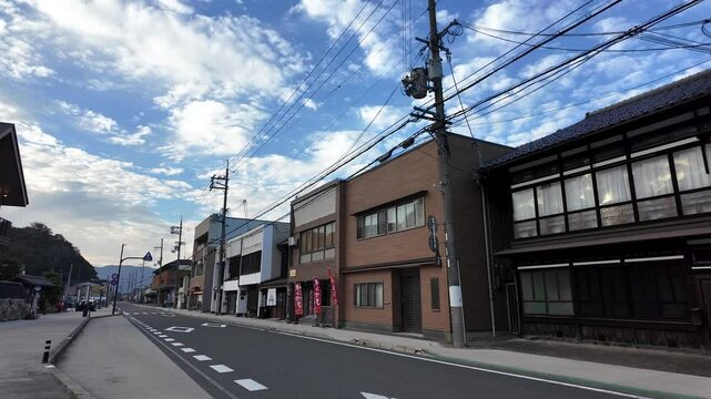 Deserted street with shops and houses under a cloudy sky near Amanohashidate Station, Kyoto, Japan