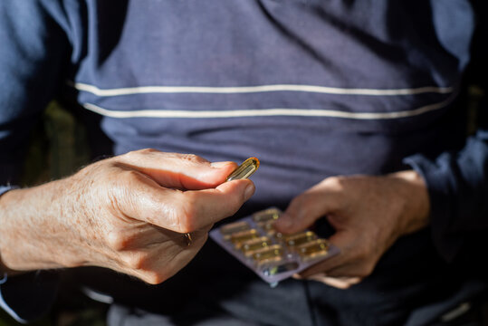 Blister pack with pills in the hands of an old man