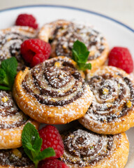 Delicious puff pastry rolls filled with cocoa cream and pistachios.