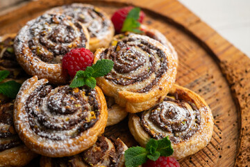 Delicious puff pastry rolls filled with cocoa cream and pistachios.