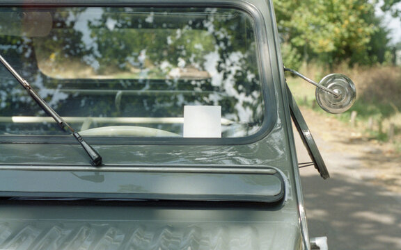 White card in a vintage car windshield