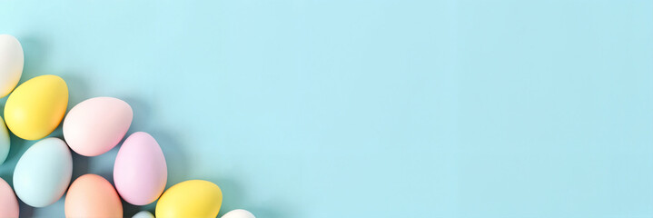 Pastel-colored Easter eggs carefully arranged on a soft blue background, celebrating spring joy. Perfect for festive greeting cards or holiday promotions.