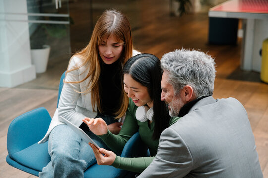 Collaborative team reviewing digital content on tablet