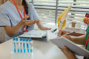 consultation between two doctors in the office, two medical students are discussing treatment...