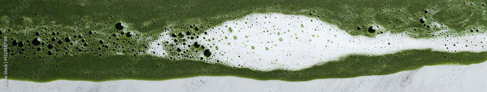 Poster abstract green liquid: an abstract macro shot of a frothy green liquid with white foam creates a vis