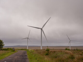 Wind turbines up on hills in the Highlands of Scotland, UK