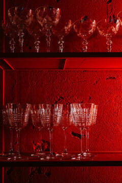 Elegant crystal glassware displayed against a red background