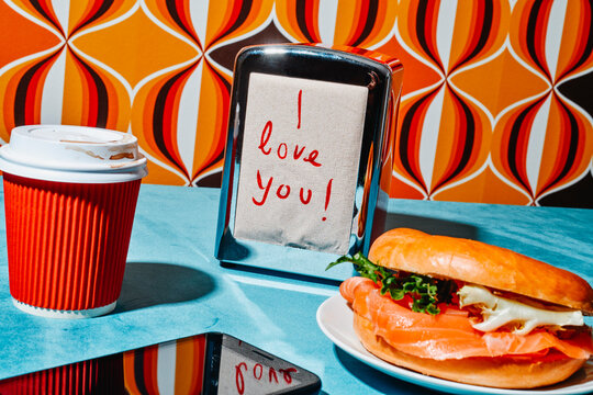 text I love you written on a napkin from a napkin dispenser