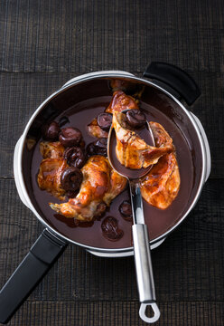 Savory Rabbit dish simmering in rich prunes sauce in a steamer