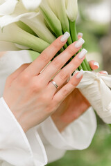 Wedding manicure and bridal bouquet. Close-up