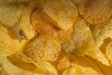 Crunchy golden potato chips in a tempting pile ready for snacking during a casual gathering