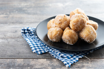 Traditional Carnival fritters or buñuelos de viento on wooden table. Copy space