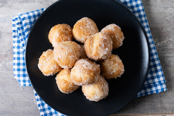 Traditional Carnival fritters or buñuelos de viento on wooden table