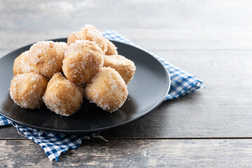 Traditional Carnival fritters or buñuelos de viento on wooden table. Copy space