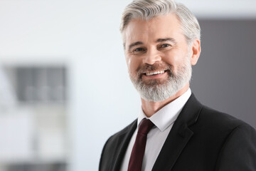 Portrait of happy banker in office, space for text
