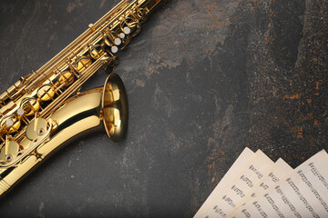 Jazz. Saxophone and musical notes on black textured table, top view. Space for text