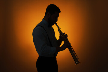 Professional musician playing soprano saxophone on color background, backlit