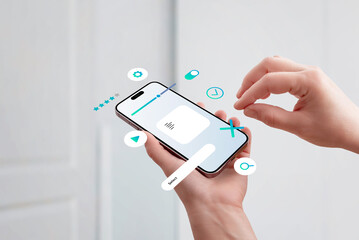 Hand holding smartphone, assembling UI elements on screen, concept of mobile app interface design...